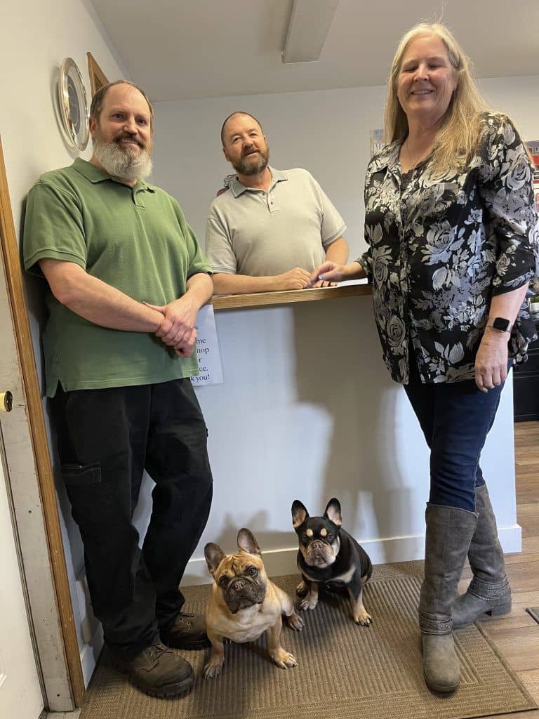 The Missoula Automotive and Transmission team with the two shop dogs in the front office